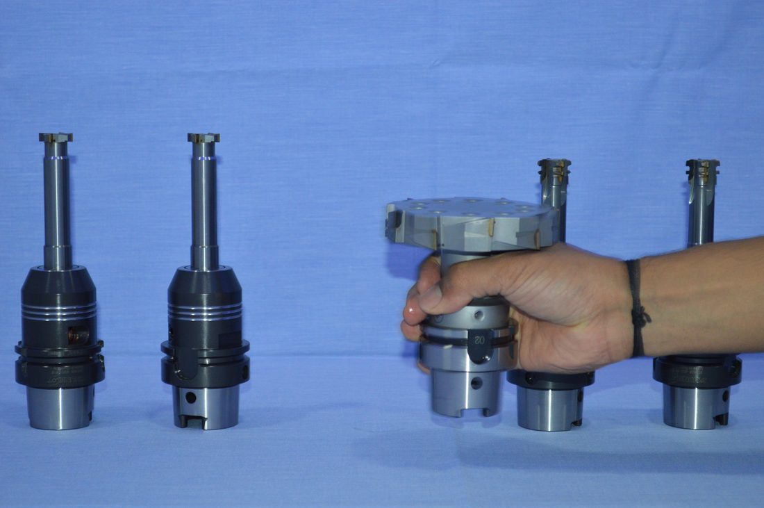 Tool holders on display, one held for scale