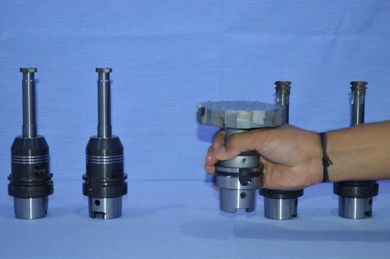 Tool holders on display, one held for scale