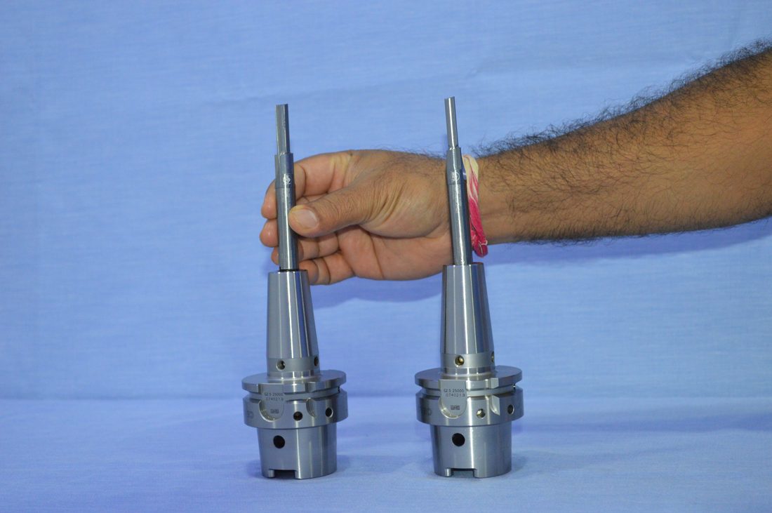 Two tool holders held up for comparison