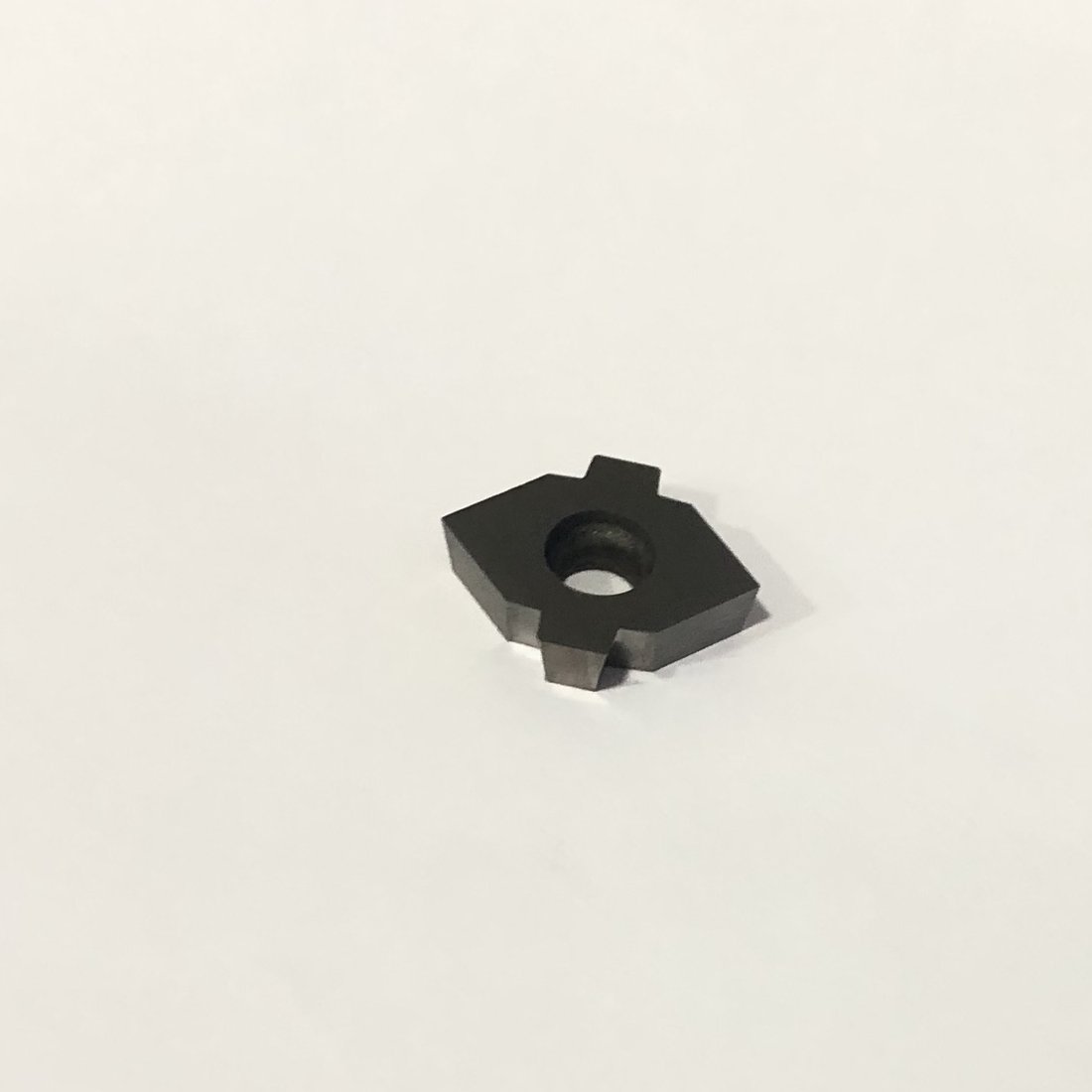 Hexagonal insert with a center mounting hole